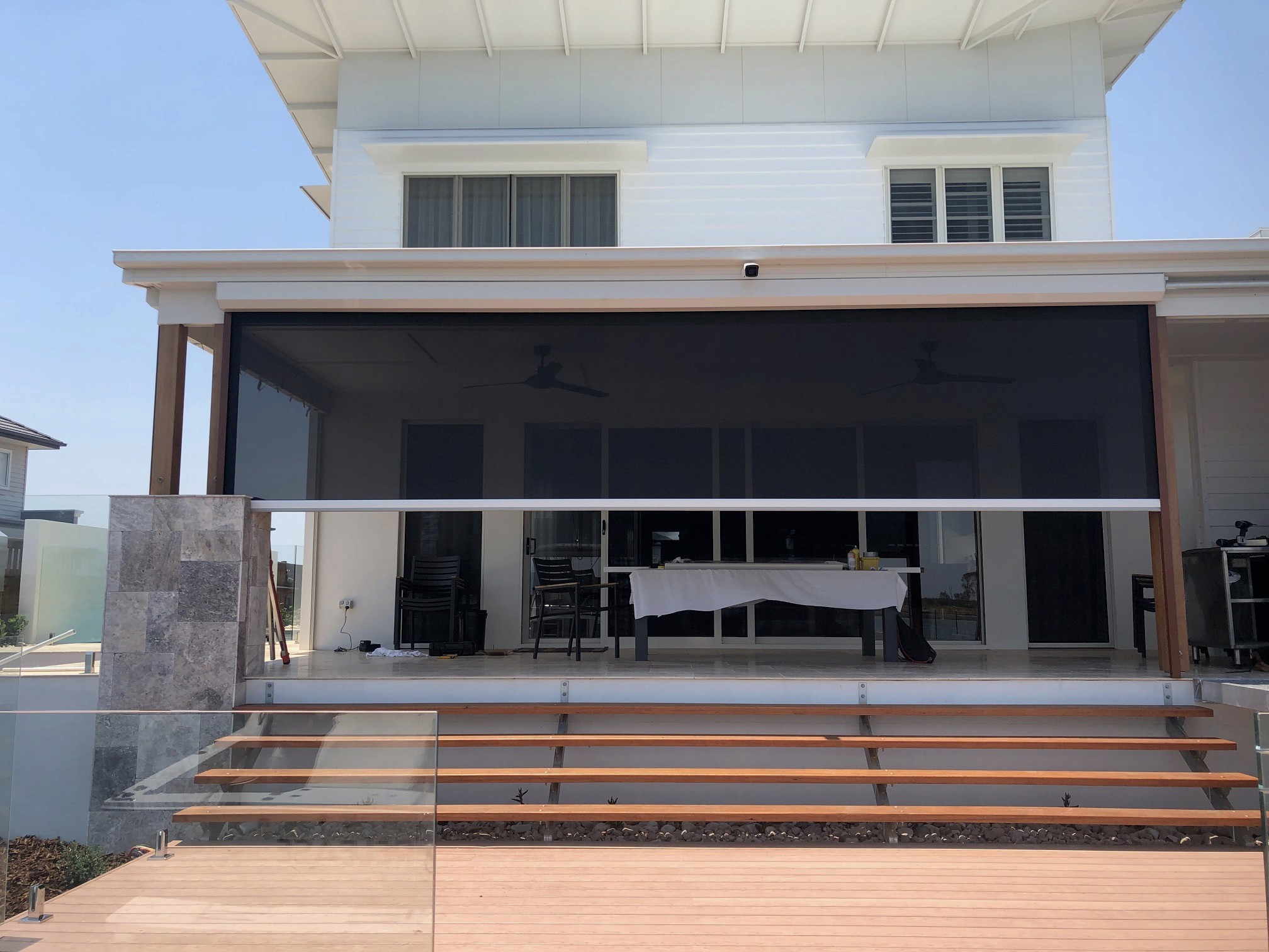 Large motorised Phantom screen enclosing the alfresco area of a Sunshine Coast home